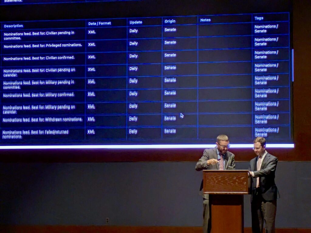 The House Digital Services Steve Dwyer and the Congressional Data Coalition's Daniel Schuman unveil version 0.1 of the Legislative Branch Data Map at the Congressional Hackathon 7.0 on September 17, 2025. Photo credit to Josh Tauberer.